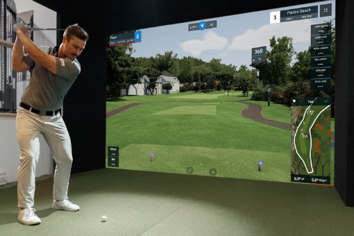 View of a golfer swinging a golf club in an enclosure