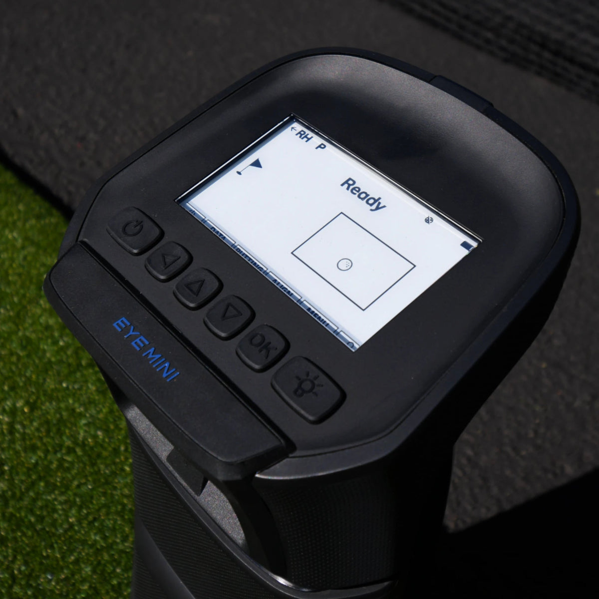 Top view of the Uneekor Eye Mini launch monitor, showcasing its button settings and screen display.